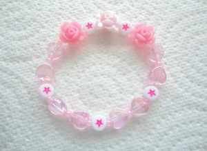 Handmade Shades of Pink  Flower Bead Elasticated Bracelet for Children.