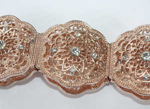 Rose Gold Tone Filigree Bracelet with 5 faux diamonds on each segment.