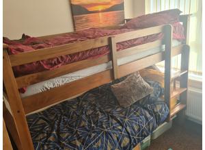 Wooden bunk beds with ladder