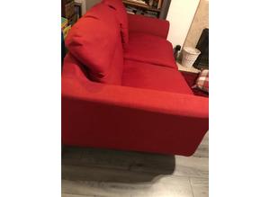 Two seater modern sofa. Red Fabric with solid aluminium legs. Good condition.