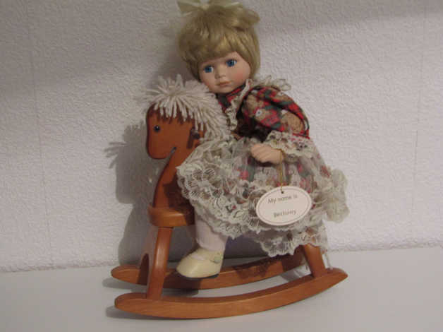 porcelain doll on rocking horse