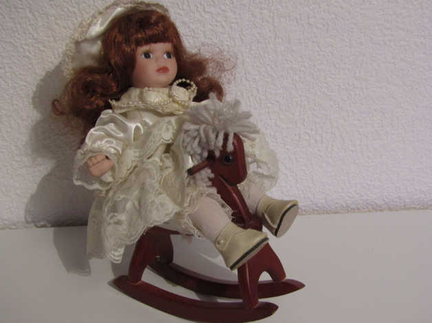 porcelain doll on rocking horse